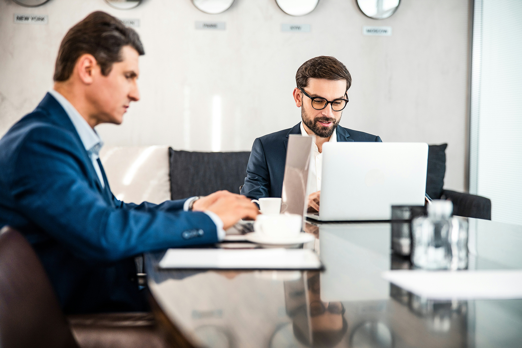 Two colleagues working across a meeting table
